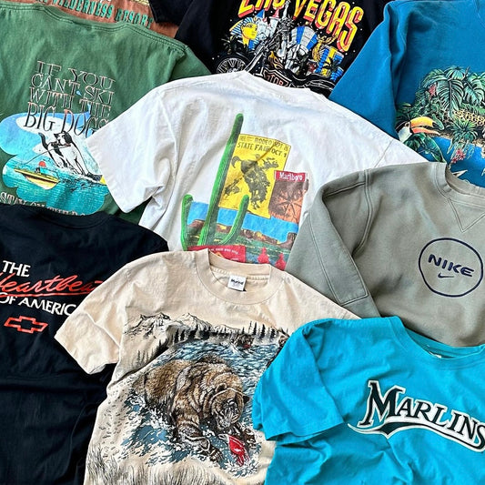 Layout of vintage tshirts: big dogs, nike crewneck, bear tshirt, marlins tee, marlboro cowboy tee, rainforest cafe tee, harley davidson las vegas tee, chevy truck tee and more.