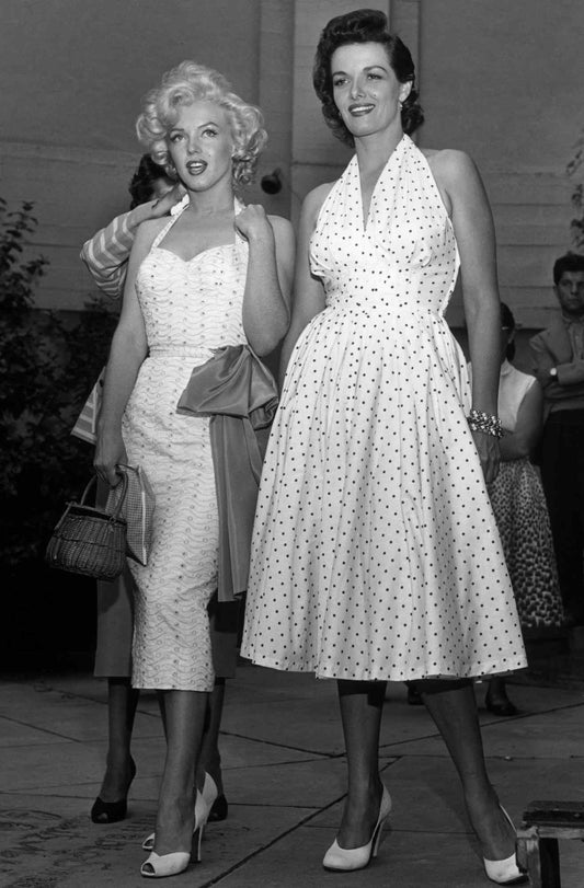 Marilyn Monroe showcasing some classic 1950s fashion trends. Poodle skirts and modest attire.