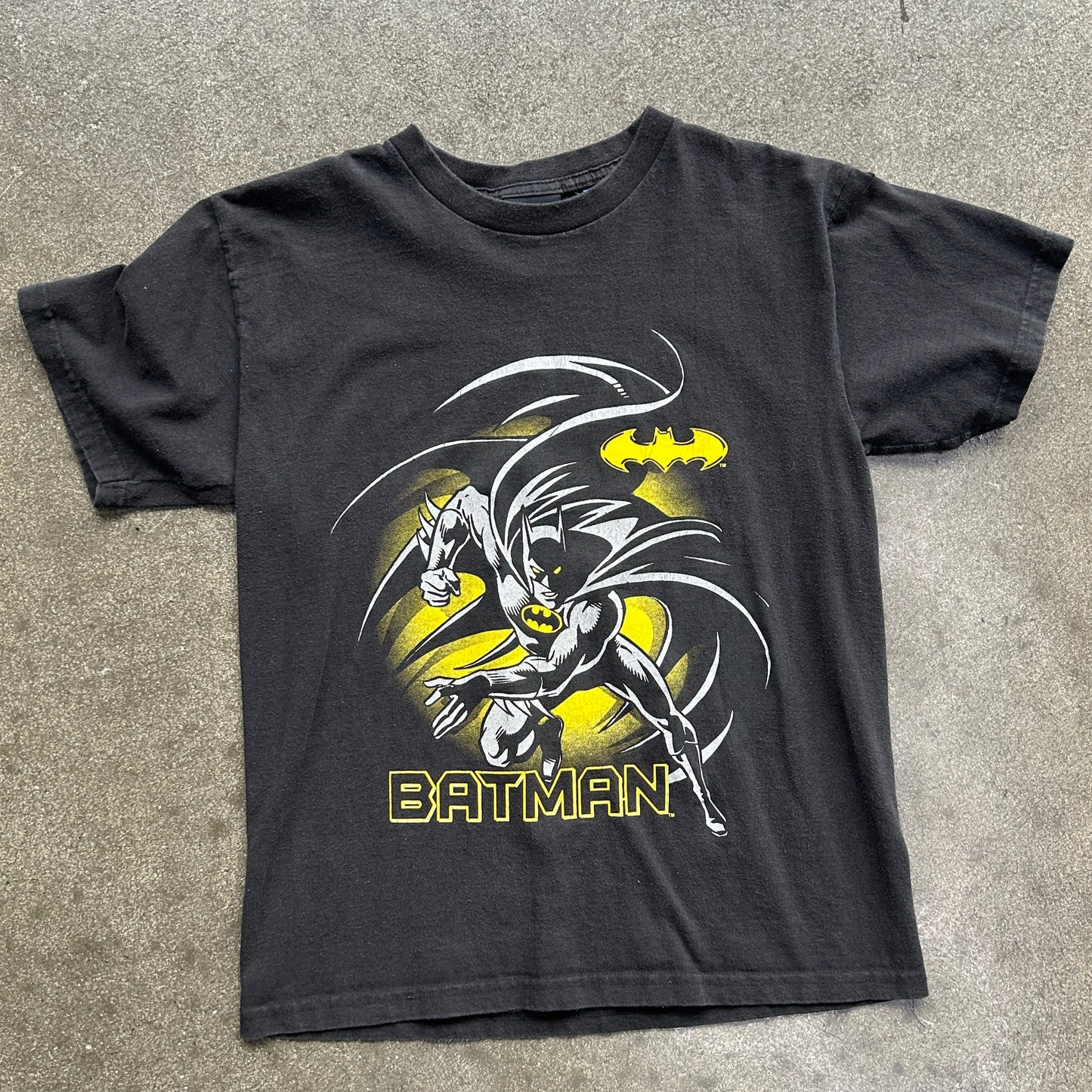 Black t-shirt with Batman graphic on a gray surface