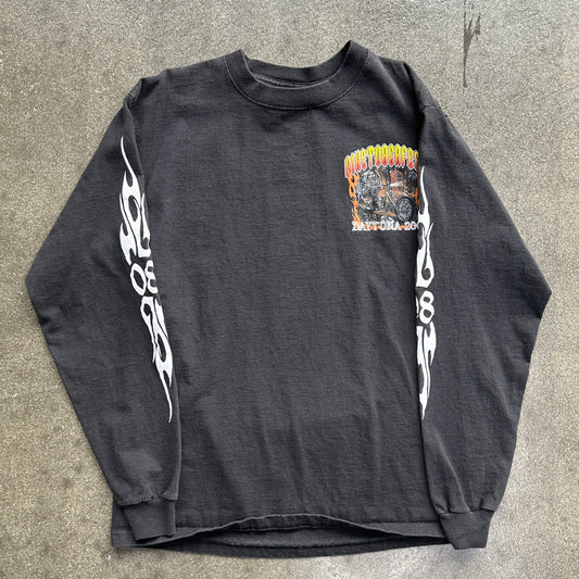 Black long-sleeve shirt with white flame designs on a gray surface