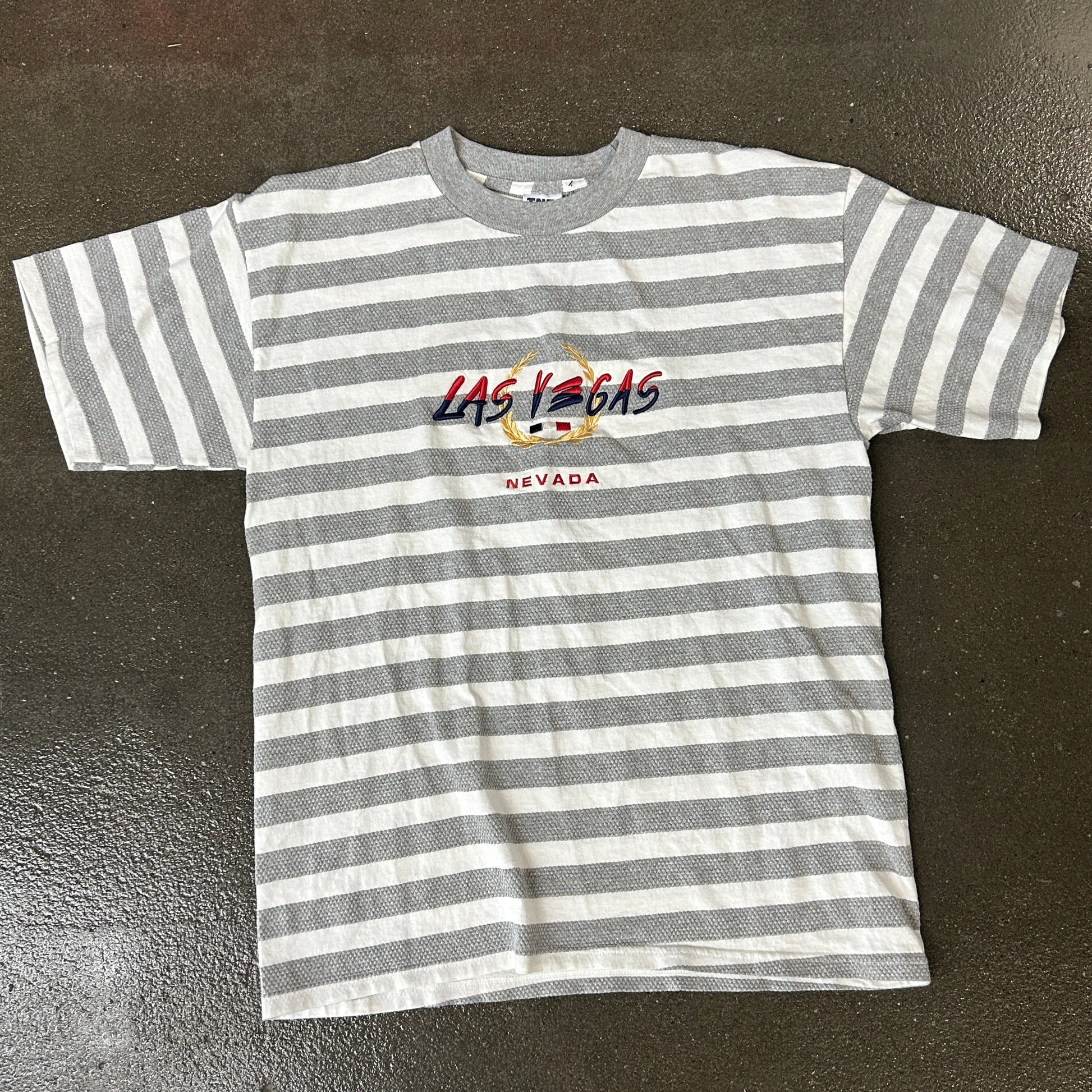 Striped t-shirt with 'Las Vegas Nevada' text on a dark surface