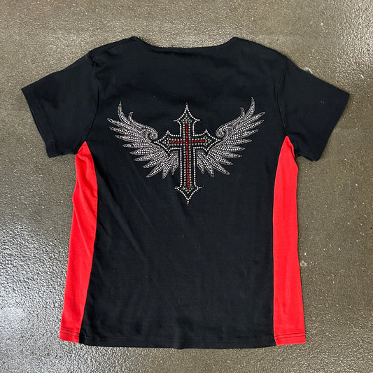 Black t-shirt with red sleeves and a decorative cross design on a metallic surface