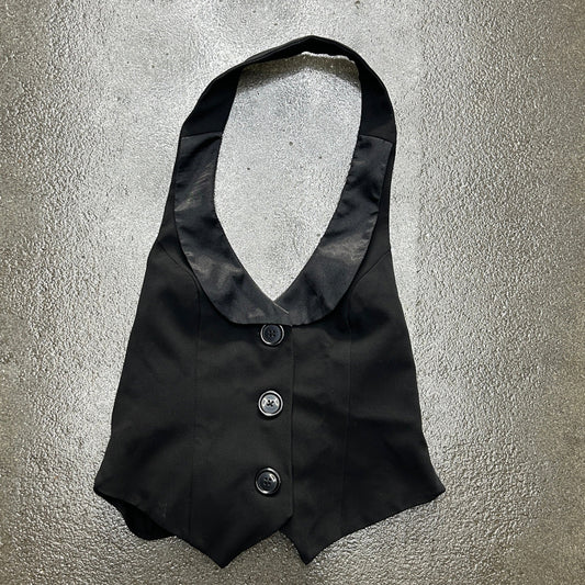 Black waistcoat with buttons on a textured gray background
