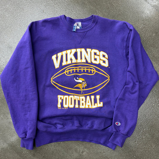 Purple sweatshirt with 'Vikings Football' text and logo on a gray surface